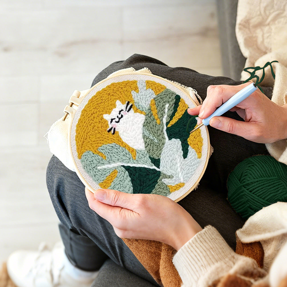 Creating handmade white cat in green leaves punch needle artwork