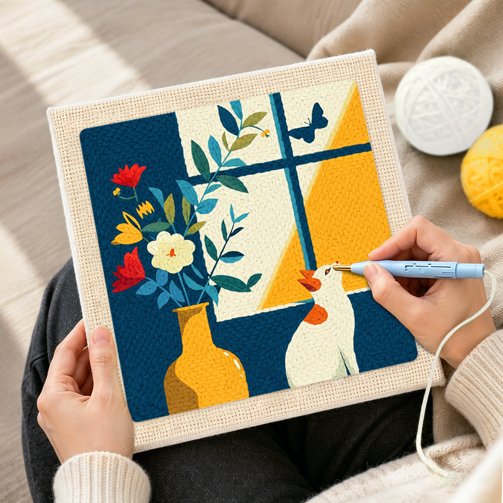 Creating handmade white cat looking at a butterfly punch needle artwork