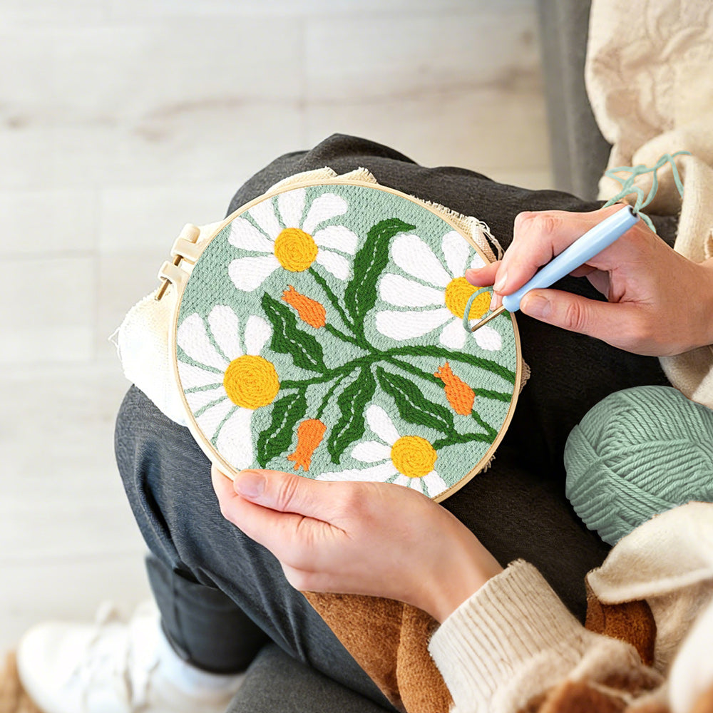 Creating handmade white chamomile punch needle artwork