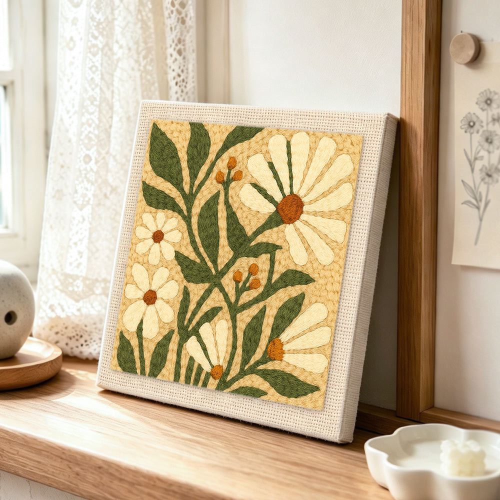 White daisies and berries punch needle artwork displayed on a table