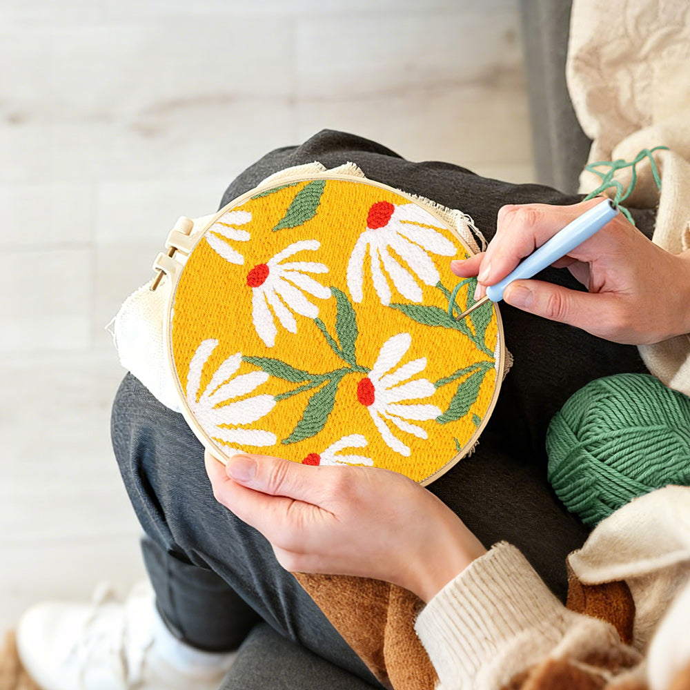 Creating handmade white daisies on a yellow background punch needle artwork