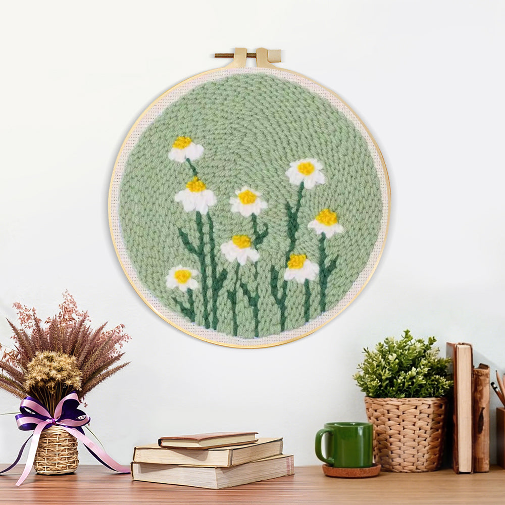 Finished white daisies on mint green background artwork displayed on a wall