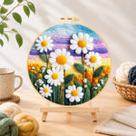 Finished white daisies on rainbow background needle felting displayed on a wooden easel