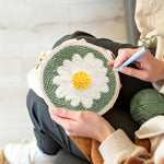 Creating handmade white daisy flower punch needle artwork