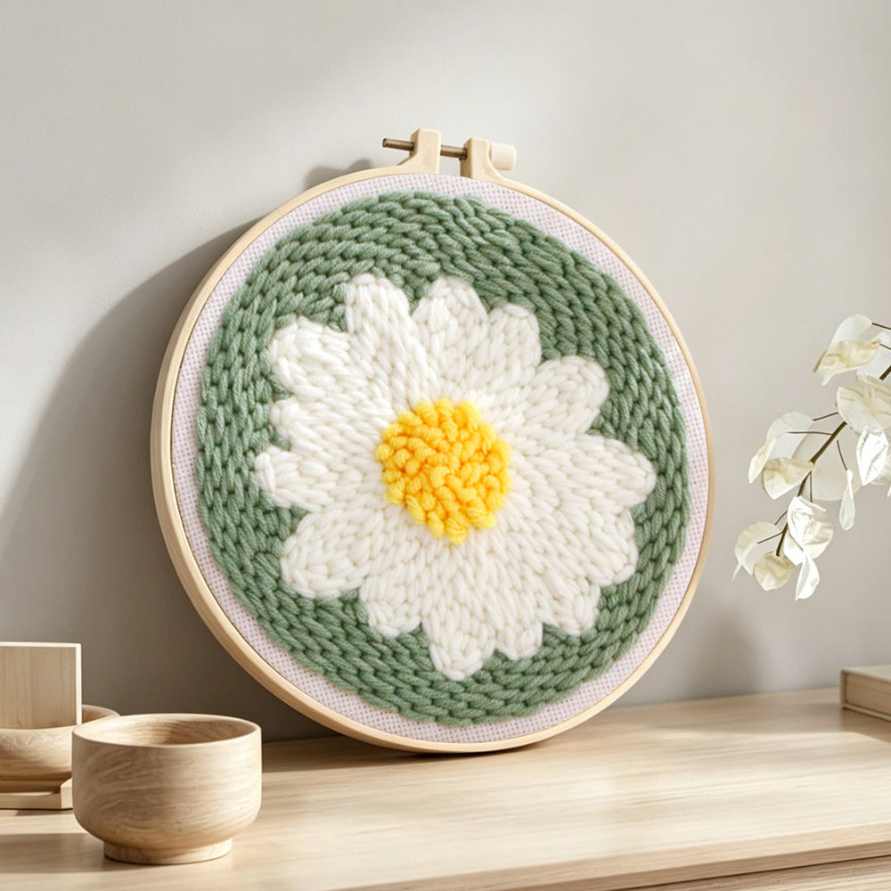 White daisy flower punch needle artwork displayed on a table