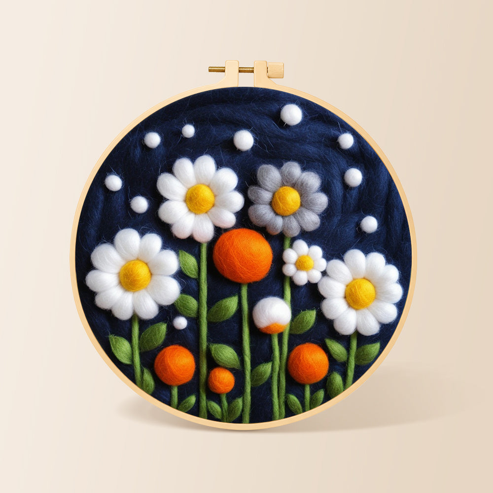 White flowers and orange orbs on navy needle felting kit for beginners with a round wooden frame