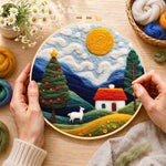 Creating the white goat and christmas tree in the hills wool painting by hand with a felting needle
