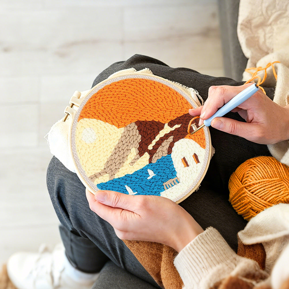 Creating handmade white house by blue sea under orange sky punch needle artwork