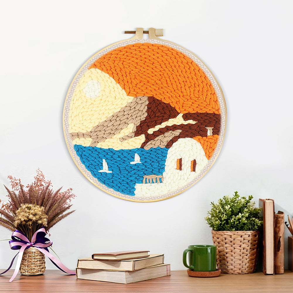 Finished white house by blue sea under orange sky artwork displayed on a wall