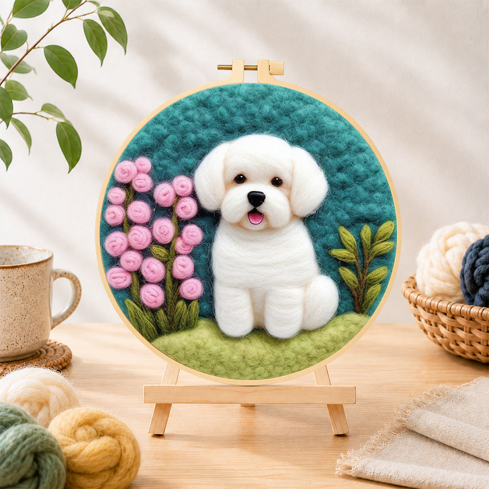 Finished white puppy with pink flowers needle felting displayed on a wooden easel
