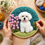 Creating the white puppy with pink flowers wool painting by hand with a felting needle