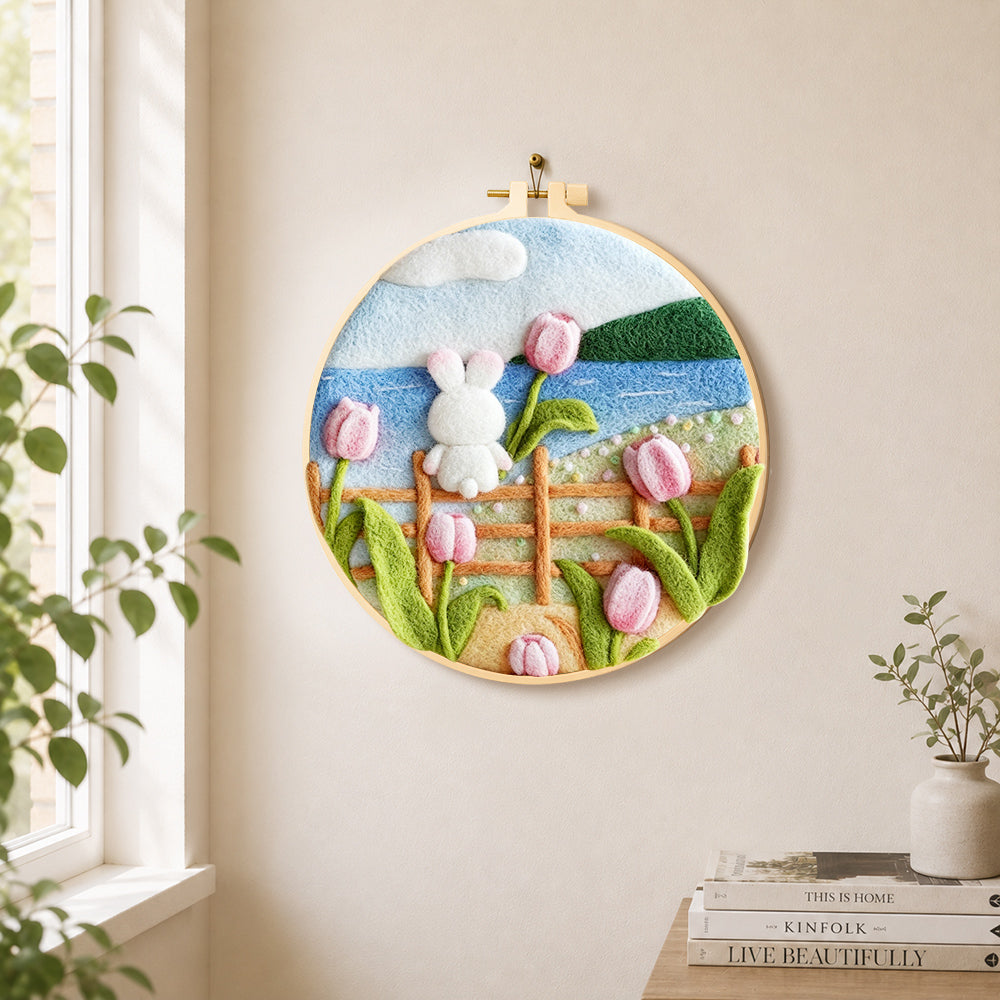 White rabbit on fence with tulips needle felt wall art displayed in a bright home interior