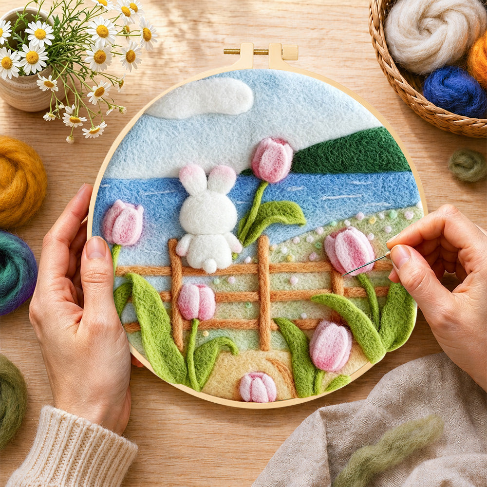 Creating the white rabbit on fence with tulips wool painting by hand with a felting needle