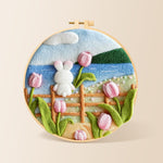 White rabbit on fence with tulips needle felting kit for beginners with a round wooden frame