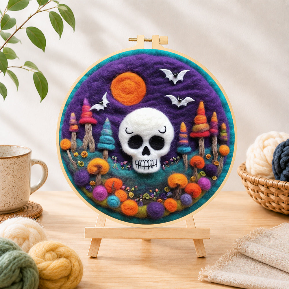 Finished white skull with colourful mushroom trees needle felting displayed on a wooden easel