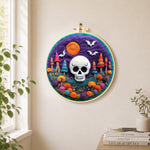 White skull with colourful mushroom trees needle felt wall art displayed in a bright home interior