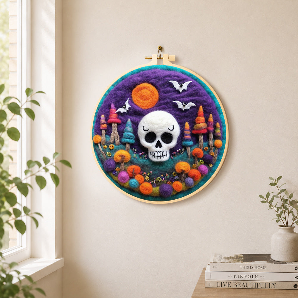 White skull with colourful mushroom trees needle felt wall art displayed in a bright home interior