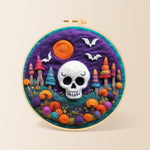 White skull with colourful mushroom trees needle felting kit for beginners with a round wooden frame