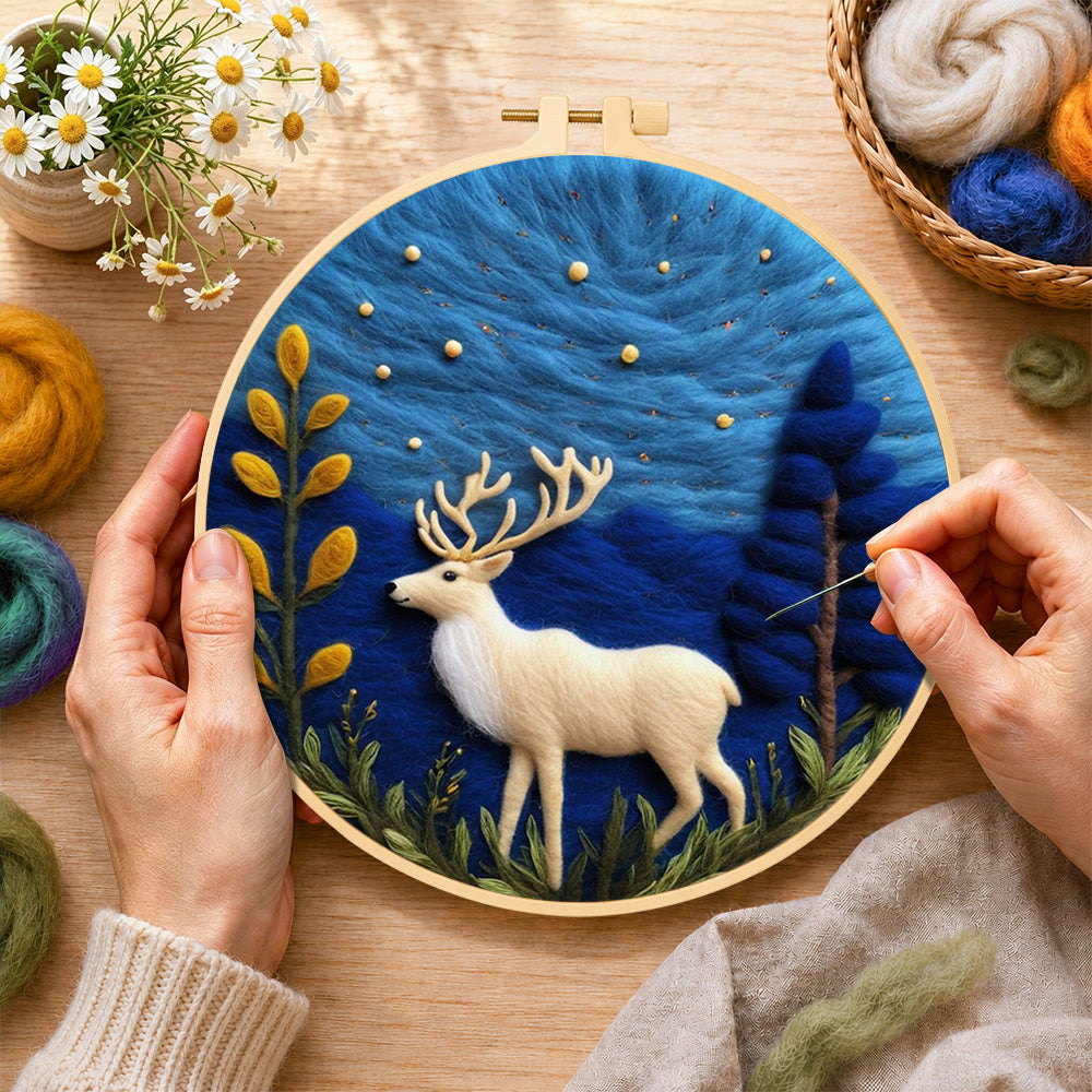 Creating the white strolling deer wool painting by hand with a felting needle