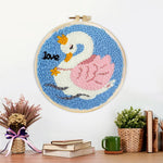 Finished white swan with pink wings artwork displayed on a wall