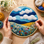 Creating the wildflowers under the vibrant blue sky wool painting by hand with a felting needle