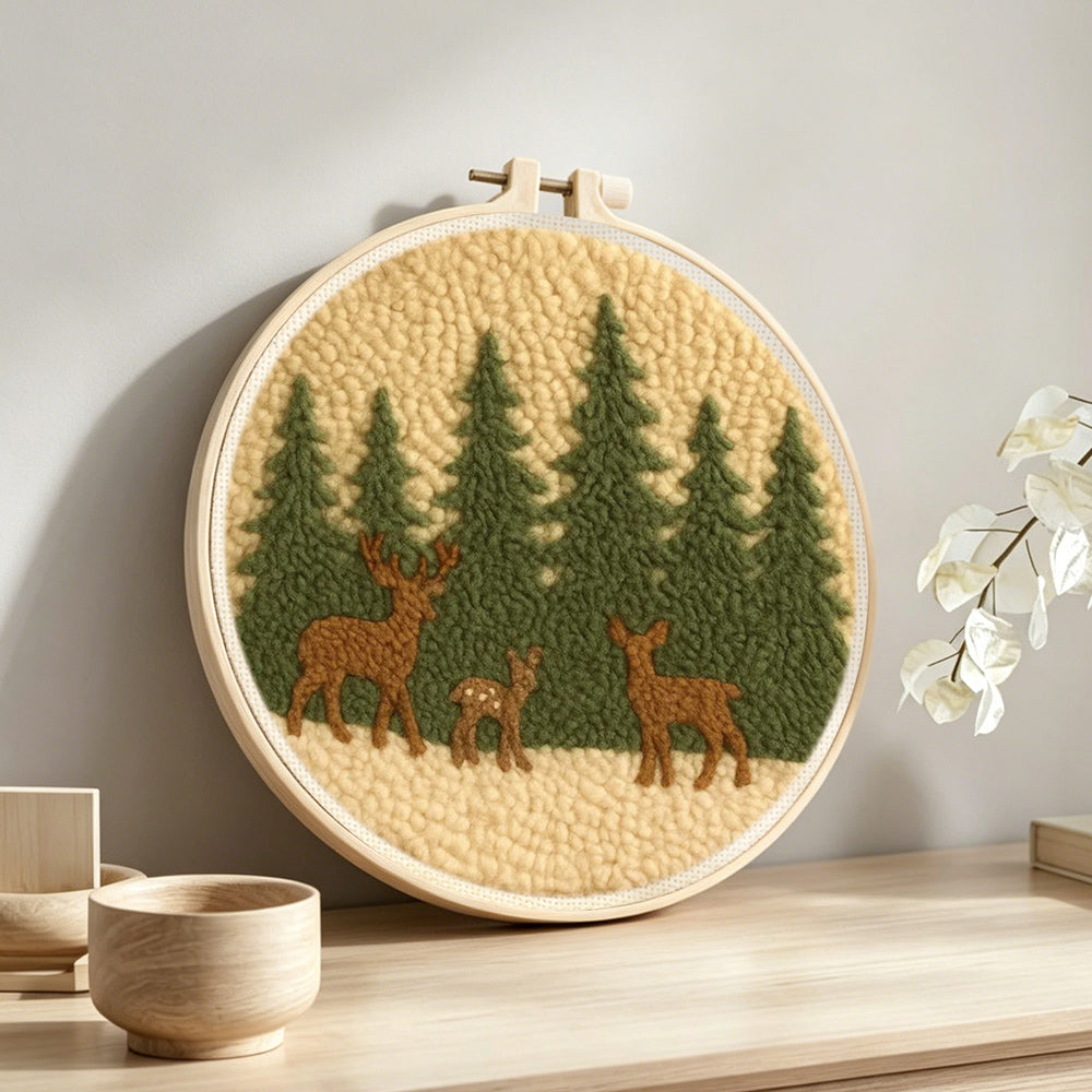 Wildlife deer and pine trees punch needle artwork displayed on a table