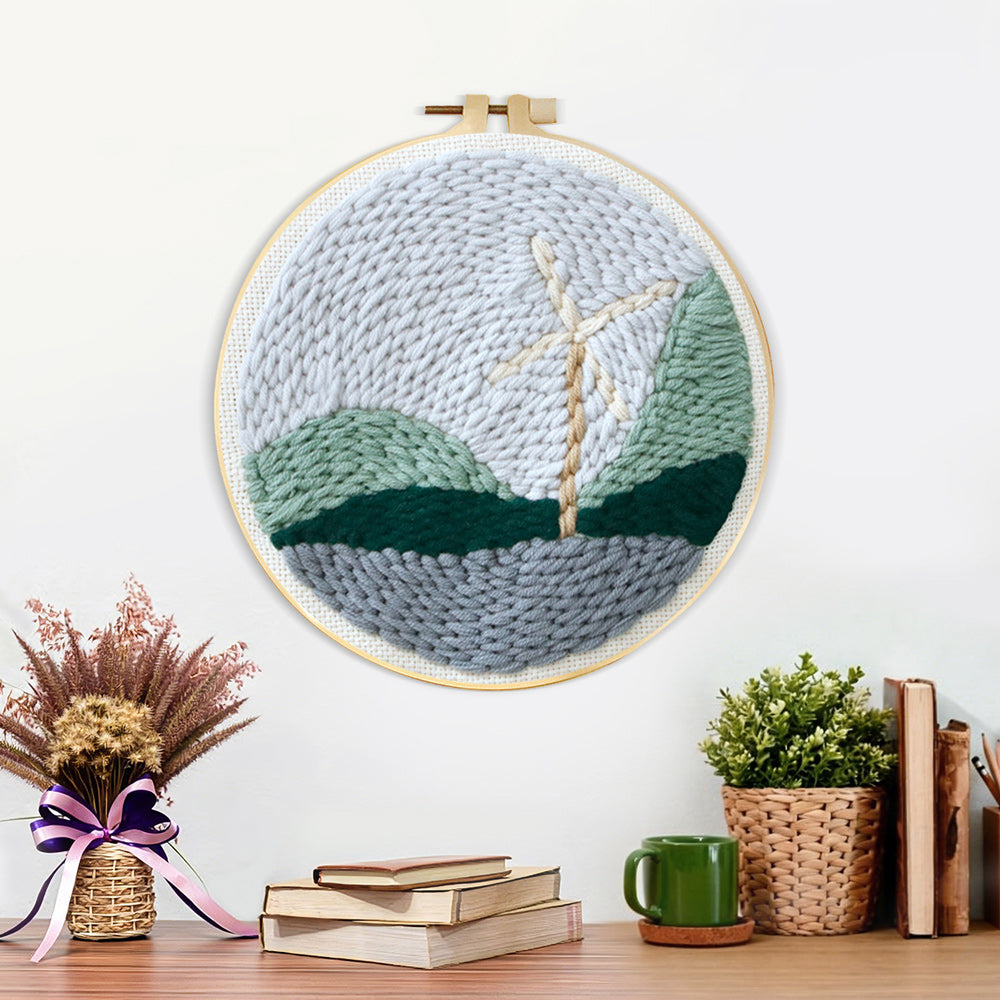 Finished windmill in mountain landscape artwork displayed on a wall