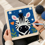 Creating handmade winking zebra starry night punch needle artwork