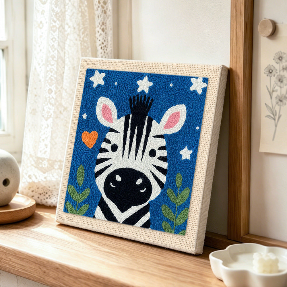 Winking zebra starry night punch needle artwork displayed on a table