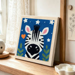 Winking zebra starry night punch needle artwork displayed on a table