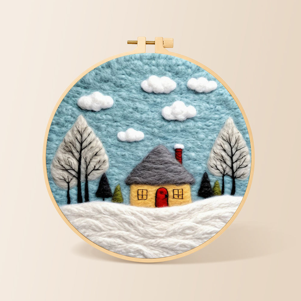 Winter cabin and snow-covered trees needle felting kit for beginners with a round wooden frame