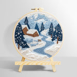 Winter cabin scene with snowy pine trees and blue river punch needle kit for beginners