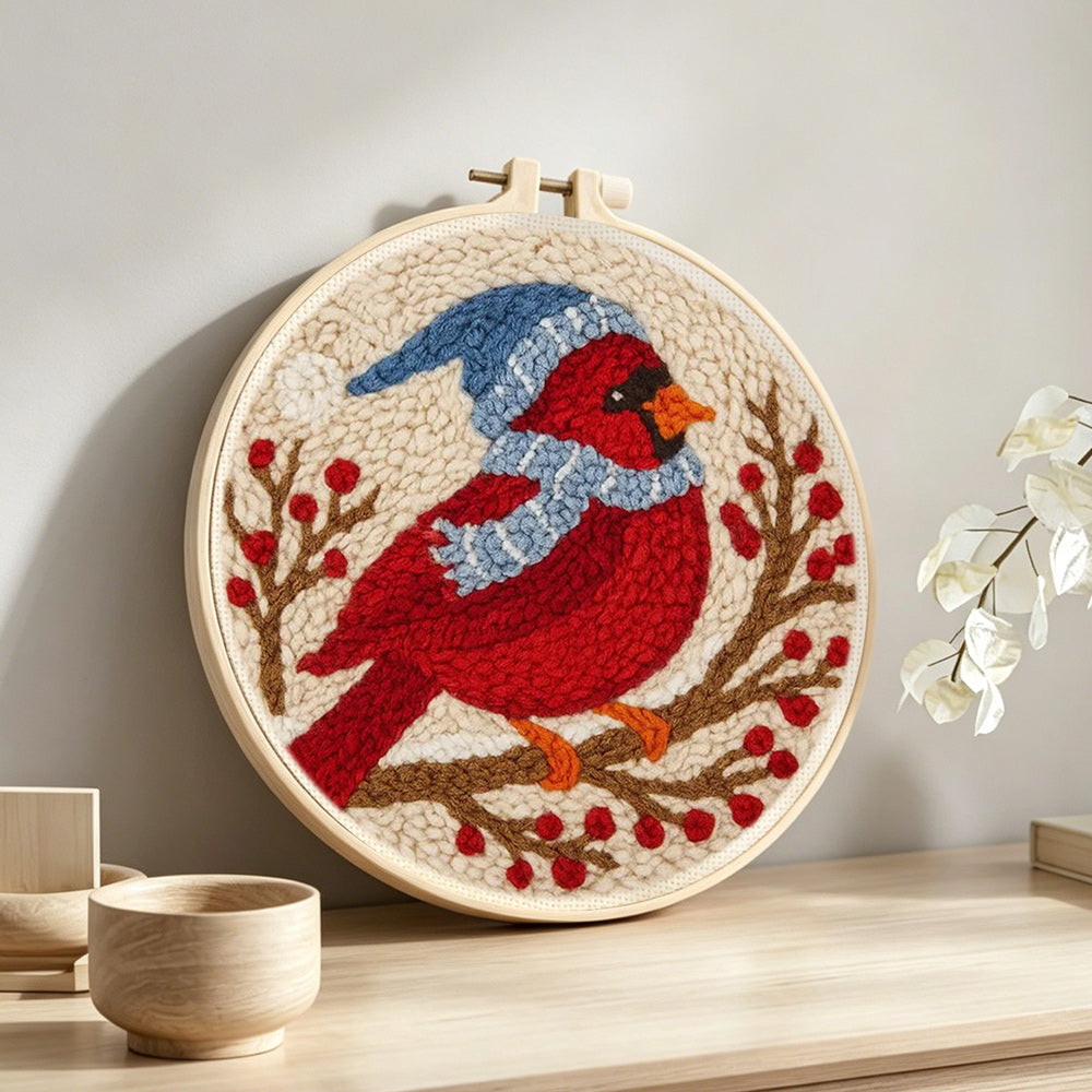 Winter cardinal on the berry branch punch needle artwork displayed on a table