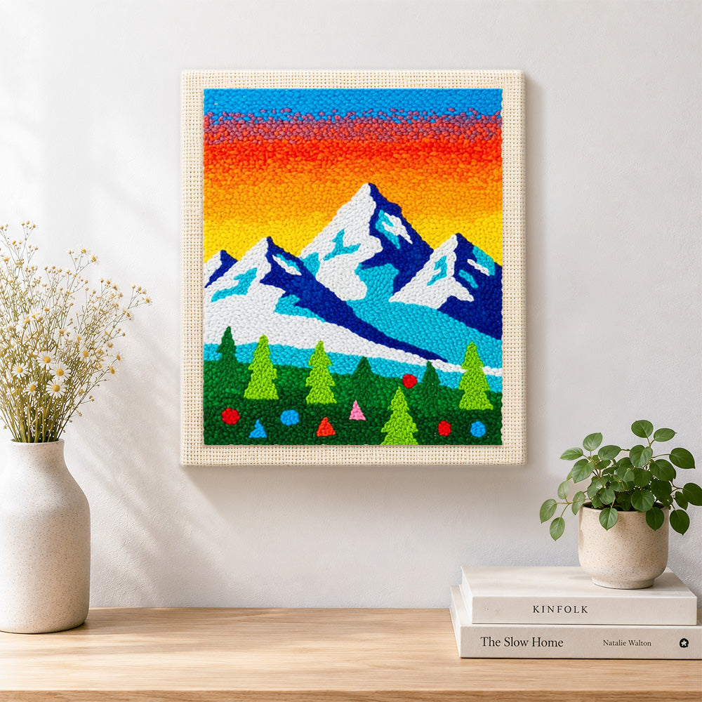 Finished winter mountains and pine forest artwork displayed on a wall