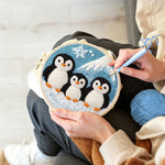 Creating handmade winter penguin family and mountain punch needle artwork