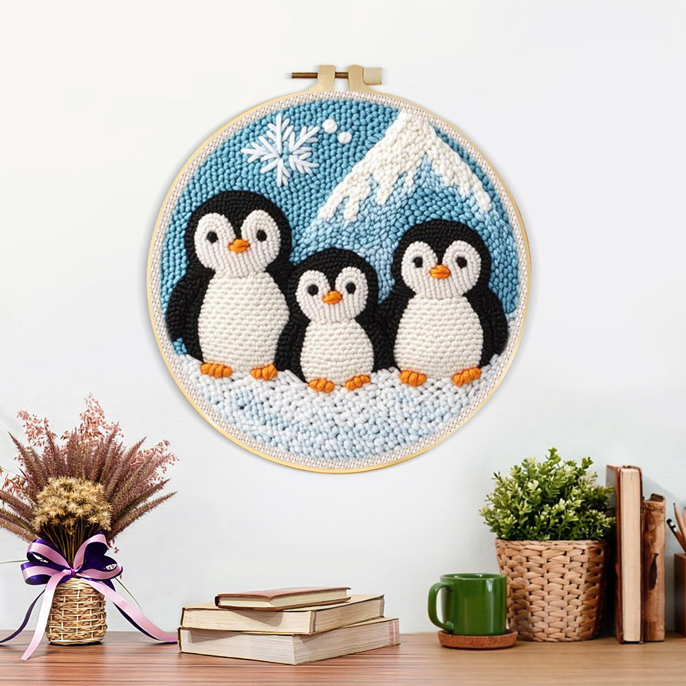 Finished winter penguin family and mountain artwork displayed on a wall