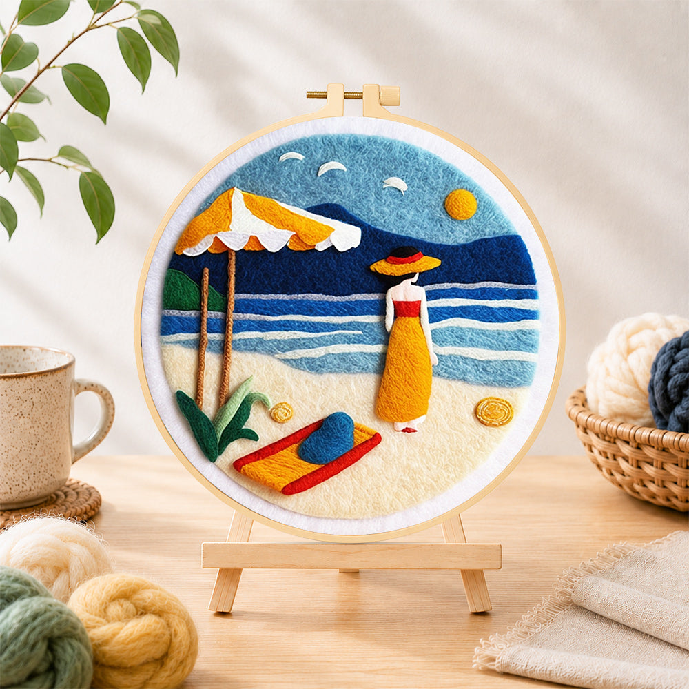 Finished woman and parasol on the beach needle felting displayed on a wooden easel