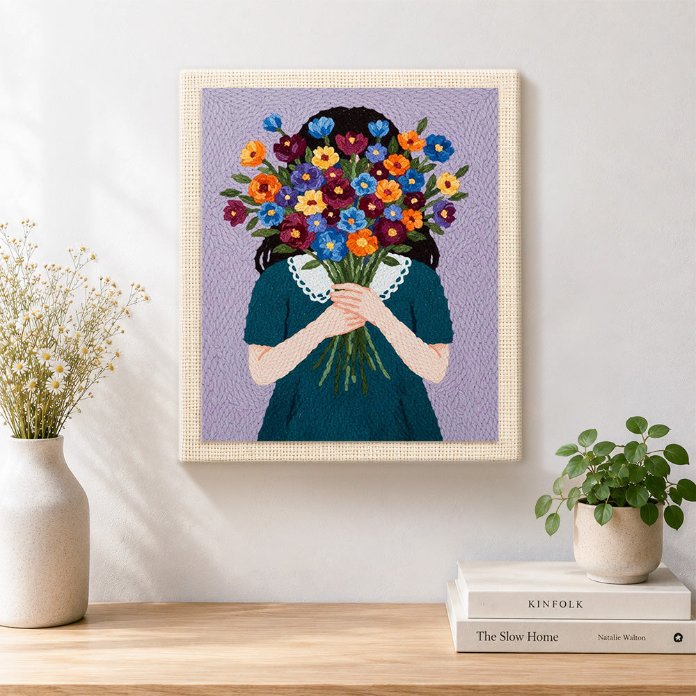 Finished woman holding flowers face hidden artwork displayed on a wall