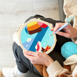 Creating handmade woman on vacation at seaside punch needle artwork