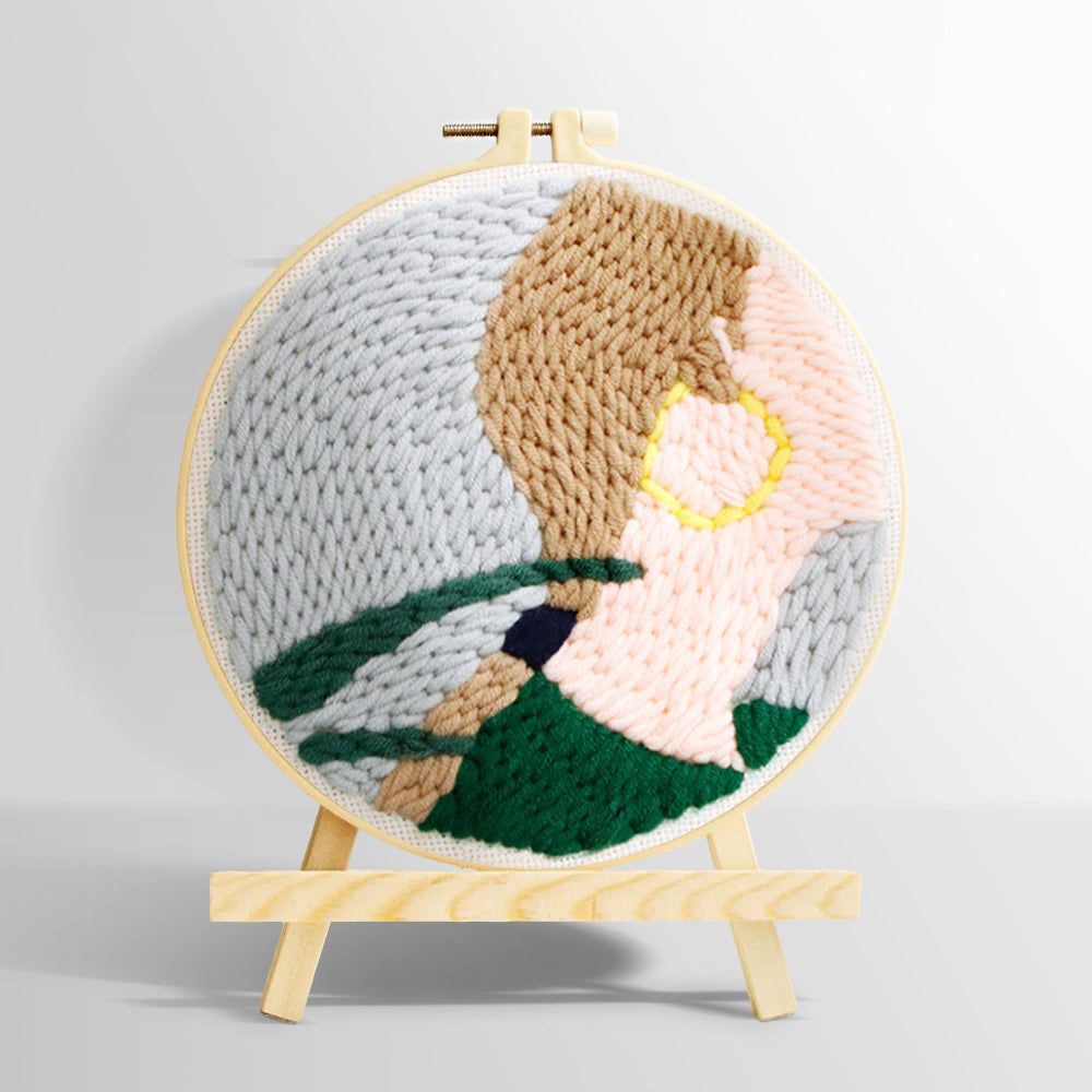 Woman wearing gold earrings punch needle kit for beginners
