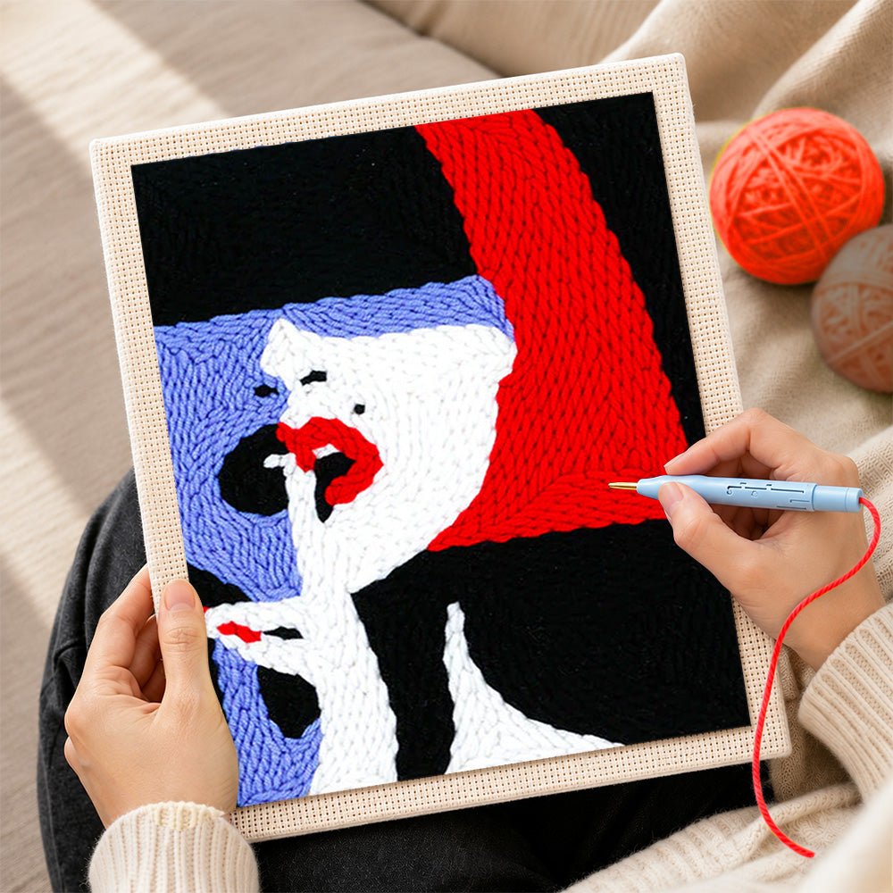 Creating handmade woman with red lips and bold hair punch needle artwork