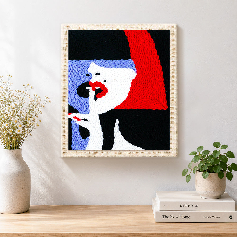 Finished woman with red lips and bold hair artwork displayed on a wall