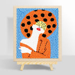 Woman with red lips in orange punch needle kit for beginners