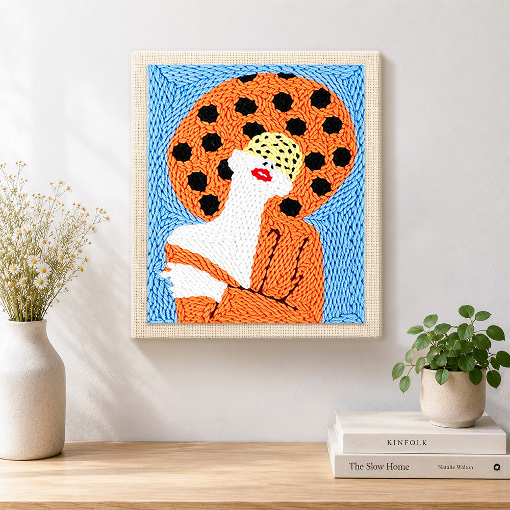 Finished woman with red lips in orange artwork displayed on a wall