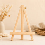 Wooden display easel stand in a warm craft room setting