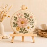 Wooden display easel stand displaying a finished punch needle embroidery project