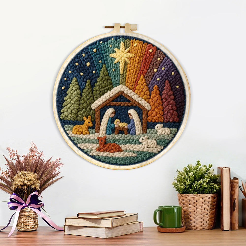 Finished wooden stable, figures and animals in a forest artwork displayed on a wall