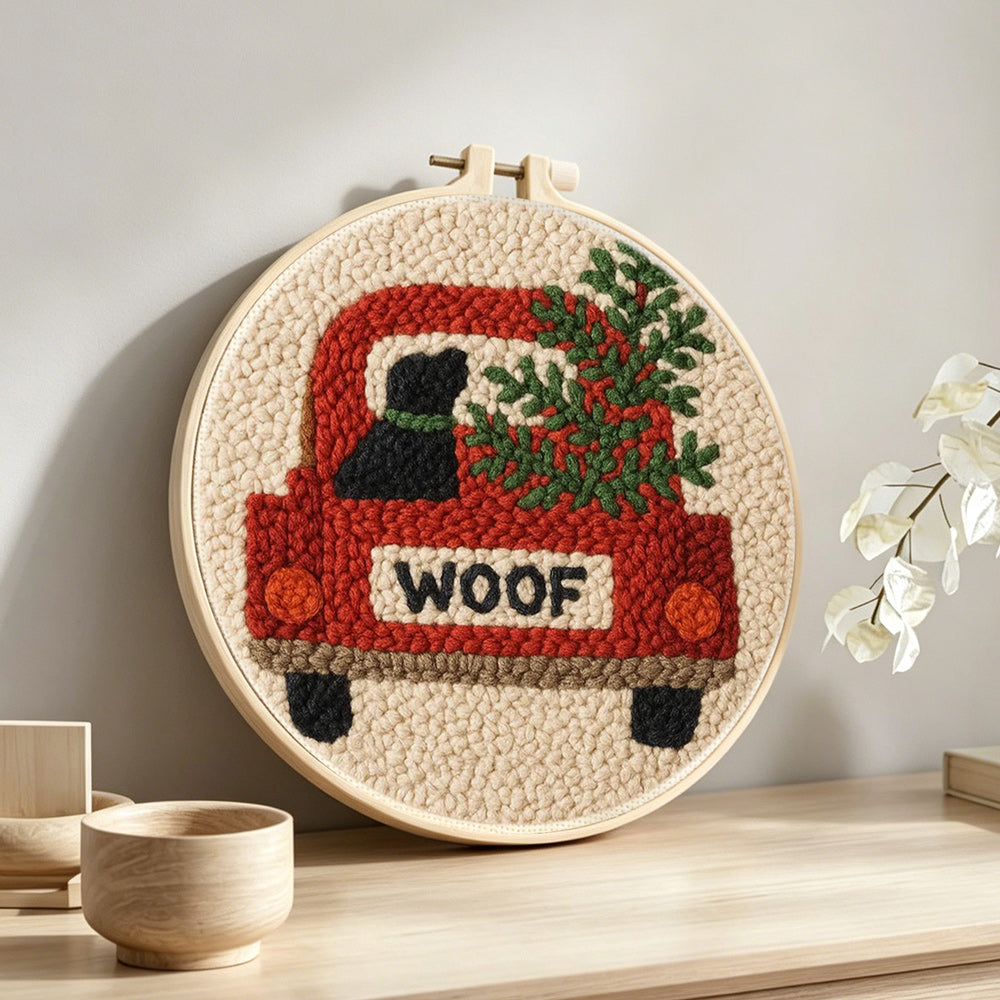 "Woof" red truck with dog punch needle artwork displayed on a table