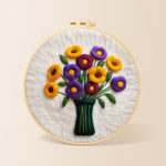 Yellow and purple flowers in vase needle felting kit for beginners with a round wooden frame