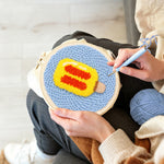 Creating handmade yellow and red ice lolly punch needle artwork